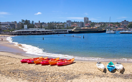 MANLY, AUSTALIA-DECEMBER 08 2013  Kayaks on Manly cove beach with the ferry in the background  Most people travel to Manly by ferry from Sydneyのeditorial素材