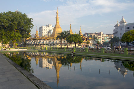 Yangon, Myanmar-May 8th 2014: Sule Pagoda reflected a pond. The pagoda is considered to be the centre of Yangon and the point from which distances to other places are measured.のeditorial素材