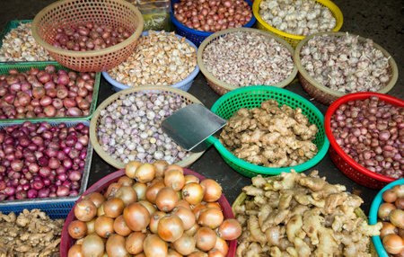 Onions, garlic, ginger and shallots for sale on market in Cholon, Ho Chi Minh CIty, Vietnamのeditorial素材