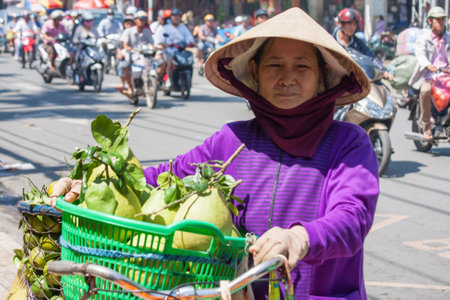 Ho Chi Minh City, Vietnam-November 2nd: A woman street vendor. Street vendors can be found all over the city.のeditorial素材