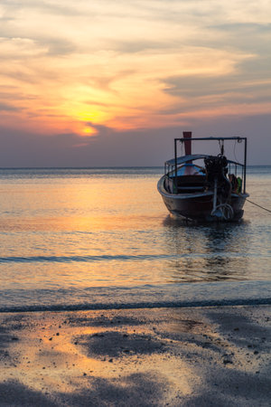 Boat at sunset on Pak Nam beach, Trang Province, Thailandのeditorial素材