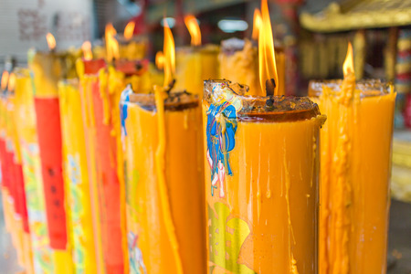Yellow wax candles burning in a Chinese temple in Bangkokの写真素材