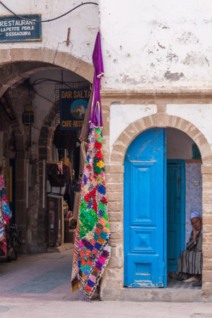 September 14th 2010 - Essaouira, Morocco: Man peering out of doorway. The fishing town is a favourite day trip for tourists.のeditorial素材