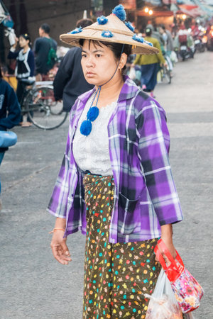 Mae Sot, Thailand - February 3rd 2019: Burmese woman in hat shopping on the market. The market is open every day.のeditorial素材