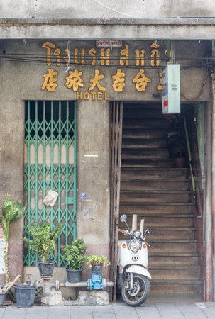 Bangkok, Thailand - March 19th 2015: Stairs entrance to old hotel and scooter, Chinatown. The area is the oldest part of the city.のeditorial素材