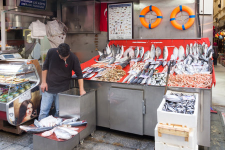 Istanbul, Turkey-Sept 19th 2015 A fishmonger checks his stock in the Beyoglu area of Istanbul. Many restaurants buy the fish as required from such establishments.のeditorial素材