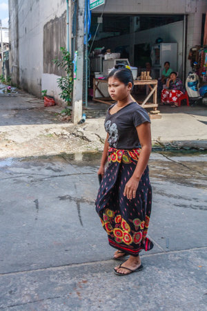Mae Sot, Thailand - November 20th 2011: Burmese woman walking down street. The town is close to the Burmese border.のeditorial素材
