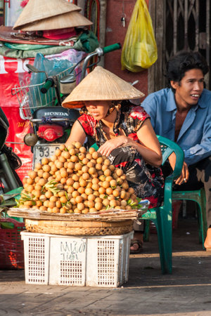 Ho Chi Minh City, Vietnam - Fruit vendor selling different fruits. Street vendors are everywhere in the city.のeditorial素材