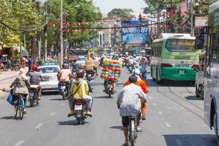 Ho Chi Minh City, Vietnam - February 24th 2010: Typical street traffic in the city. There are thousand of motorcycles on the roads.のeditorial素材