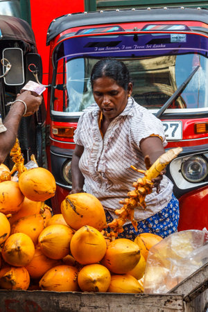 Colombo. Sri Lanka - December 21st 2016: Woman buying coconuts in the Pettah district. This is the main commercial area.のeditorial素材