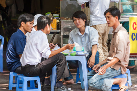 Ho Chi Minh City, Vietnam - February 24th 2010: Young Vietnamese men talking and smoking. Young...