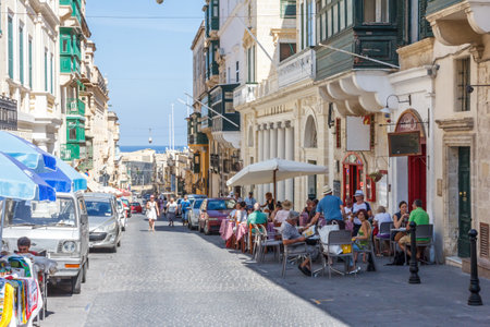 Valetta, Malta - September 13th 2015: Tourists sat outside on the main street. The city is a popular port with cruise ships.のeditorial素材
