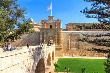 Valetta, Malta - September 13th 2015: Tourists using the bridge across to the Mdina. The walled city...