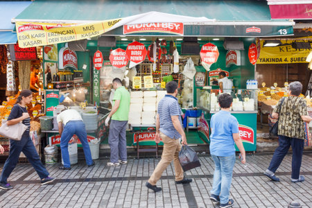 Istanbul, Turkey - September 21st 2015: Shoppers walking past a cheese stall outside the Spice...