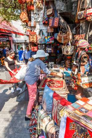 Istanbul, Turkey - September 21st 2015: Tourists shopping, outdoor market. The shops are full of souvenirs.のeditorial素材