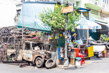 Bangkok, Thailand - 29th March 2018: A typical corner of Chinatown. There are several abandoned vehicles in the area.のeditorial素材