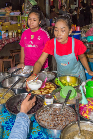 Siem Reap, Cambodia - 15th January 2018:Serving Cambodian desserts in the Old Market. The market is open every day for local produce.のeditorial素材