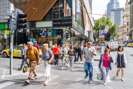 Melbourne, Australia - 21st February 2018: People crossing a street using a pelican crossing. Most...