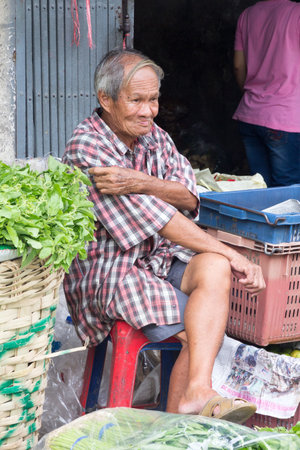 Bangkok, Thailand - July 9th 2015: Vegetable vendor at Pak Khlong Talat market waiting for business. The market is famous for flowers and vegetables.のeditorial素材