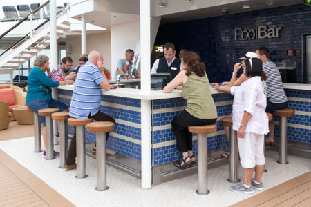 Barcelona, Spain - September 7th 2015 : People at the  pool bar onboard the Celebrity Equinox cruise ship. Bars are popular places onboard.のeditorial素材