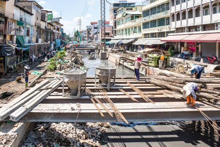 Bangkok, Thailand - 25th September 2018: Construction workers working on a canal, Chinatown, Bangkok, Thailandのeditorial素材