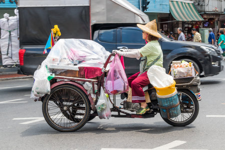 Bangkok, Thailand - 26th September 2018: Woman riding  a motorised three wheeler. They are often used for food trucksのeditorial素材
