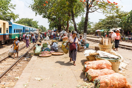 Yangon, Myanmar - May 5th 2014: Market being held on  railway station platform. Vendors sell their wares to train passengers.のeditorial素材