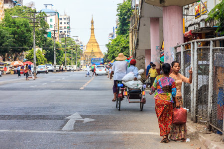 Yangon, Myanmar - May 4th 2014 : Typical street scene. Sule Pagoda is in the backgroundのeditorial素材