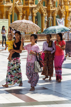 Yangon, Myanmar - May 6th 2014: People visiting the Shwedagon Pagoda. The pagoda is the most sacred in all of Myanmar.のeditorial素材