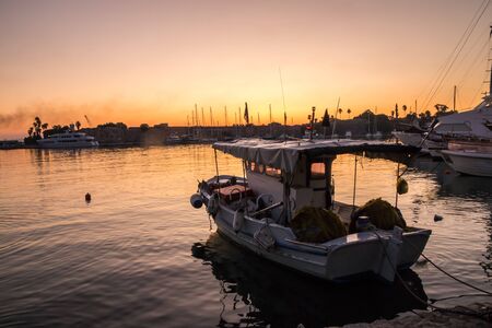 Sunrise over fishing boat in the harbour, Kos, Greece