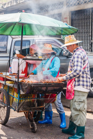 Bangkok, Thailand - January 5th 2010: Street food vendors barbecuing chicken. Street food is very popular in the city.のeditorial素材