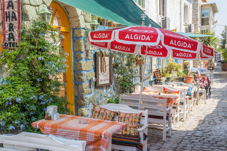 Alacati, Turkey - September 4th 2019: Typical restaurant in cobbled street. The town is popular with tourists in summerのeditorial素材