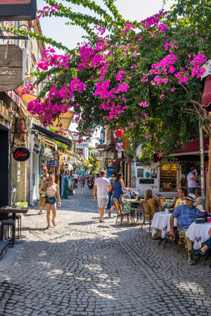 Alacati, Turkey - September 4th 2019: People eating in a cafe restaurant. The town is a popular tourist destination.のeditorial素材