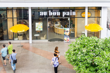 Bangkok, Thailand - August 7th 2017: People walking past Au Bon Pain, Ratchadamri. The cafe chain has branches all over Bangkok.のeditorial素材