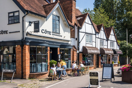 Amersham, England - August 22nd 2019: People sat outside the Cote Brasserie and coffee shop. Many people sit outside on sunny days.のeditorial素材