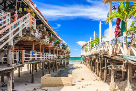 Hua HIn, Thailand - July 12th 2010: View bewteen 2 restaurants on stilts to the beach. The area is famous for its seafood restaurantsのeditorial素材