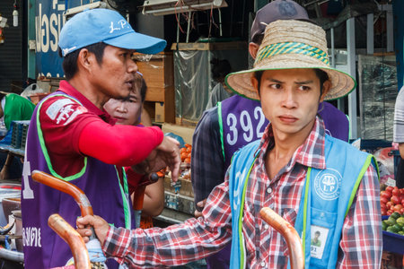 Bangkok, Thailand - November 14th 2015: Porters waiting for business on Khlong Toei market. This is the city's largest wet market.のeditorial素材