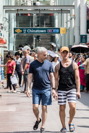 Singapore - July 5th 2019: Tourists on Pagoda Street in Chinatown with the MRT station in the background. The road is pedestrianised.のeditorial素材