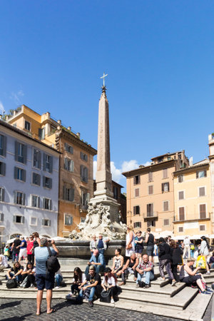 Rome, Italy - 19th September 2017:  Tourists sitting by the Fontane del Pantheon, Piazza della Rotunda. The city is thronged with tourists during the summer months.のeditorial素材