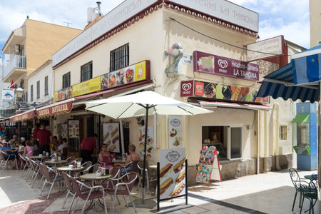 Carihuela, Spain-August 23rd 2015: People in a cafe on the  main street. Carihuela is a beach resort in Torremolinos.のeditorial素材