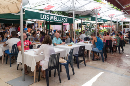 Carihuela, Spain-August 23rd 2015: People in a busy restaurant. Carihuela is a beach resort in Torremolinos.のeditorial素材