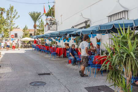 Mijas, Spain - August 27th 2015: Tourists eating and drinking in a cafe. The town is popular with both expats and tourists.のeditorial素材