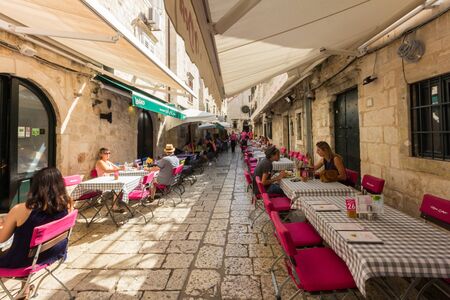 Dubrovnik, Croatia - 24th September 2017: Street restaurant old Dubrovnik. The city is considering limiting the number of cruise ships due to overcrowding.の写真素材
