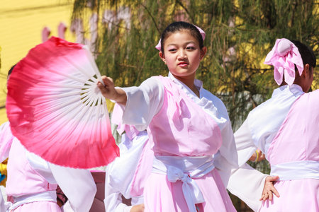 Khon Kaen, Thailand - November 21st 2009. Young dancer in Silk Festival parade. The festival is an annual event.のeditorial素材