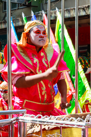 Khon Kaen, Thailand - November 21st 2009. Drummer in the Silk Festival parade. The festival is an annual event.のeditorial素材