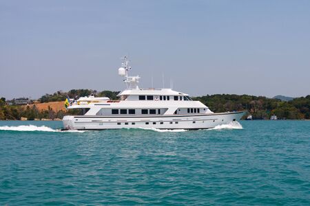 Motor yacht underway in Phang Nga Bay off Phuket, Thailandの写真素材