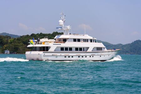 Motor yacht underway in Phang Nga Bay off Phuket, Thailandの写真素材