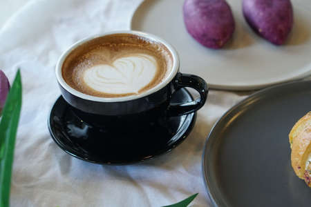 hot latte coffee on white tableの写真素材