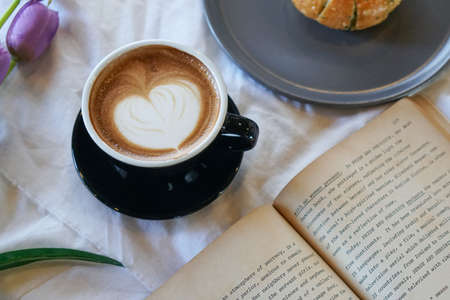 hot latte coffee on white tableの写真素材