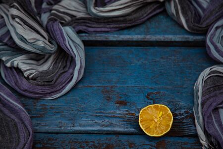 an old, ugly lemon, lying on a blue wooden backgroundの写真素材